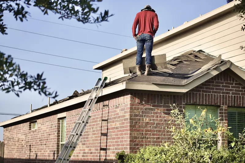 Professional roofer working on a residential roof in Ivystone Farms